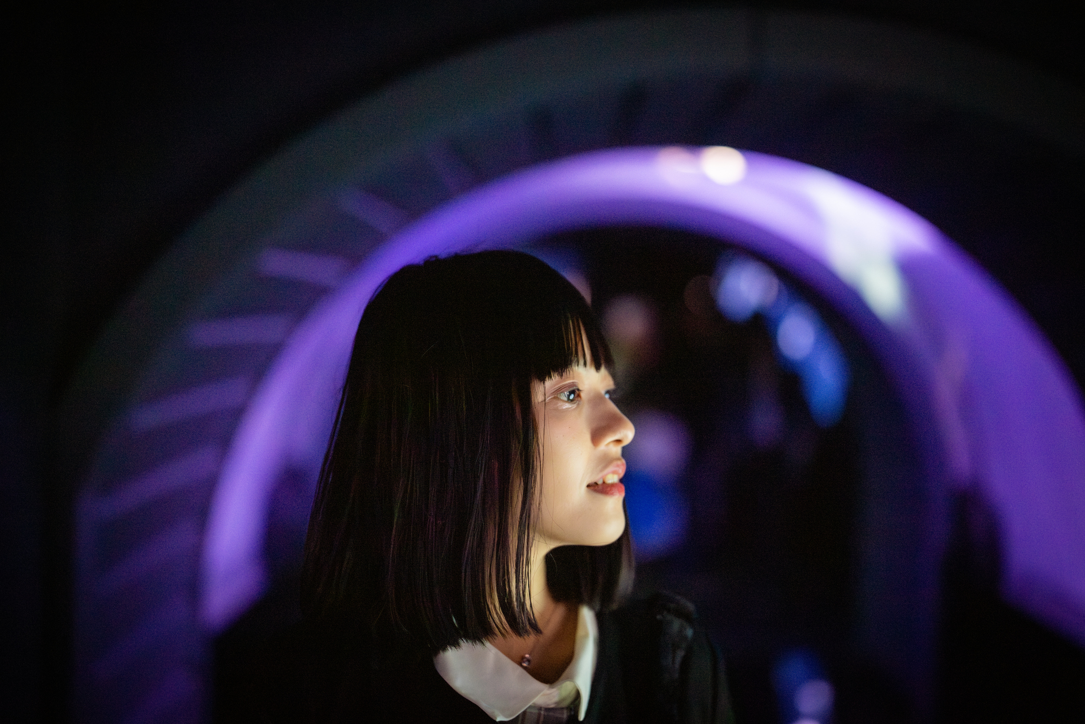 A person stepping toward a glowing archway of light, the public front door of a business.
